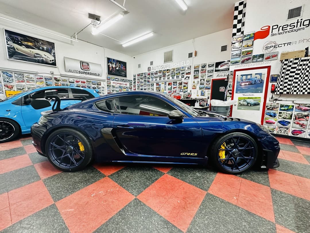 Inside Auto SuperShield's Boca Raton studio — Porsche GT4 RS on the checker floor