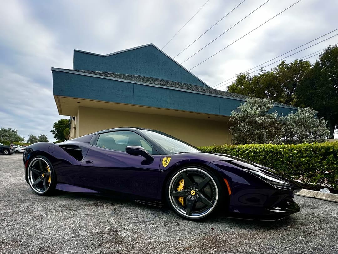 Ferrari finished in a deep purple sitting in the Auto SuperShield showroom